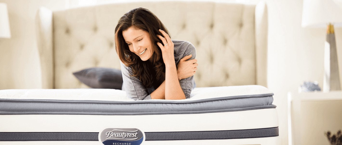 A woman relaxing on a Beautyrest pillow-top mattress